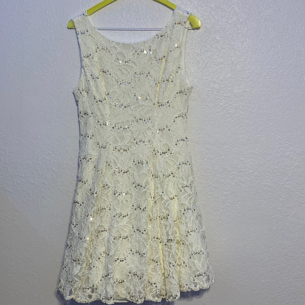 B. Darlin brand size 9/10. White lace material with sequins.